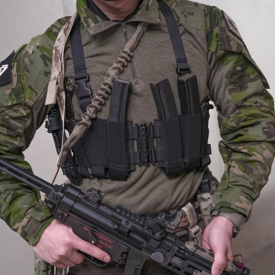 Ez-Rig VTG Edition chest rig showcased by a soldier in tactical gear, featuring a center split design and elastic bands.