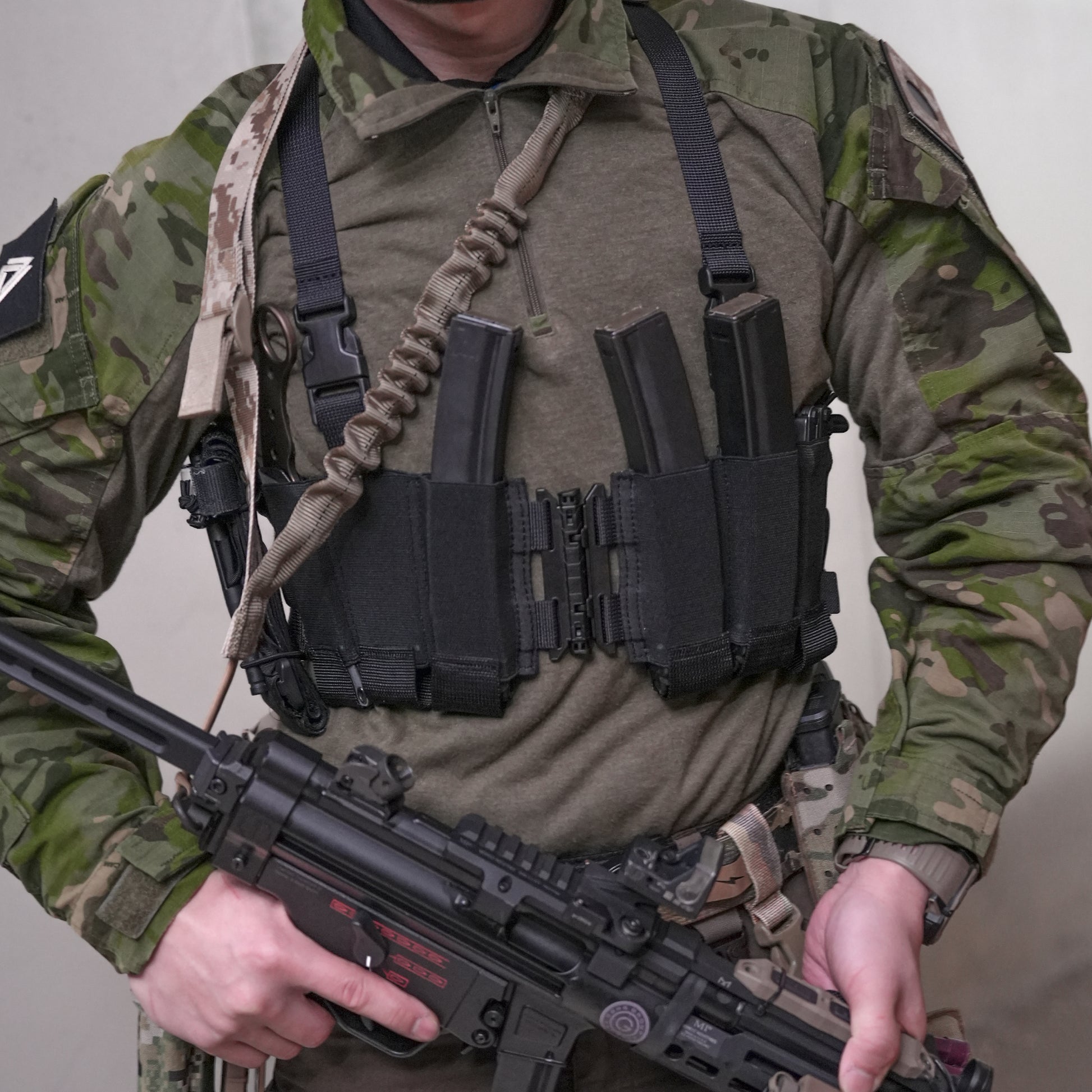 Ez-Rig VTG Edition chest rig showcased by a soldier in tactical gear, featuring a center split design and elastic bands.